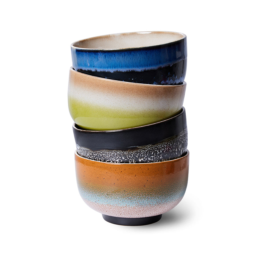 Stack of colorful ceramic bowls on a white background