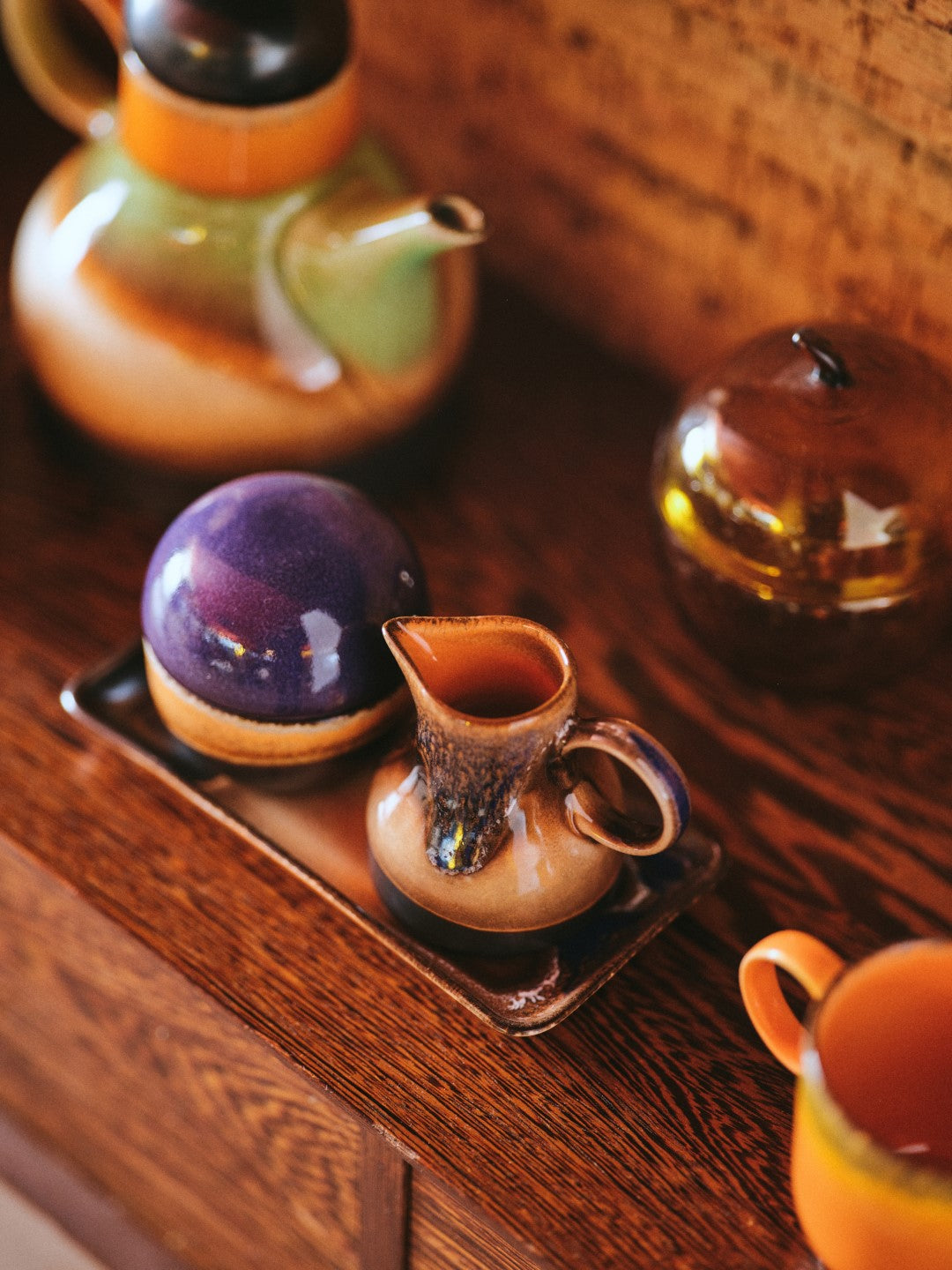 retro style creamer in brown tones with reactive glaze finish and texture with sugar pot on small tray