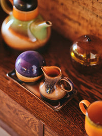 retro style creamer in brown tones with reactive glaze finish and texture with sugar pot on small tray