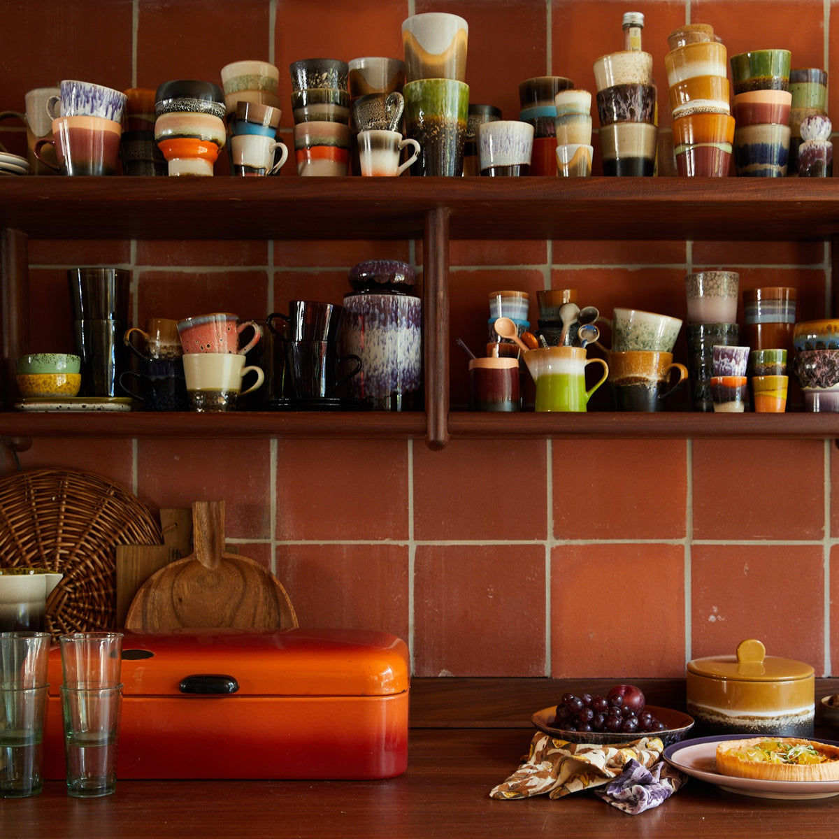 open shelving, orange terra tiles and retro style ceramics