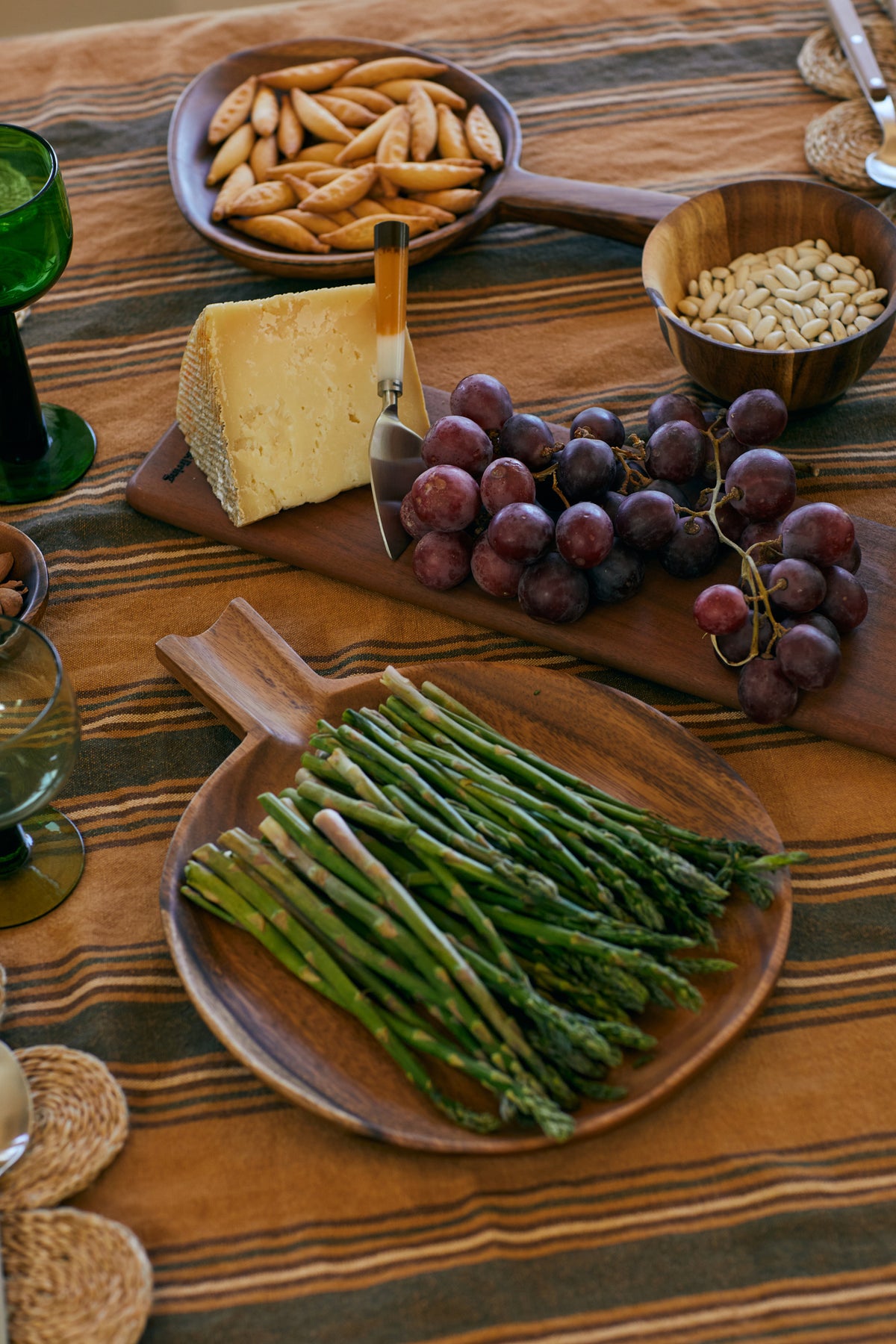 acacia wooden serving platter with green asparagus