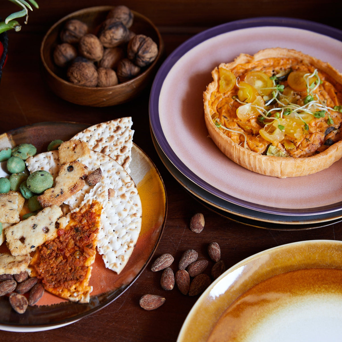 pink and purple colored stoneware dinner plates with quiche