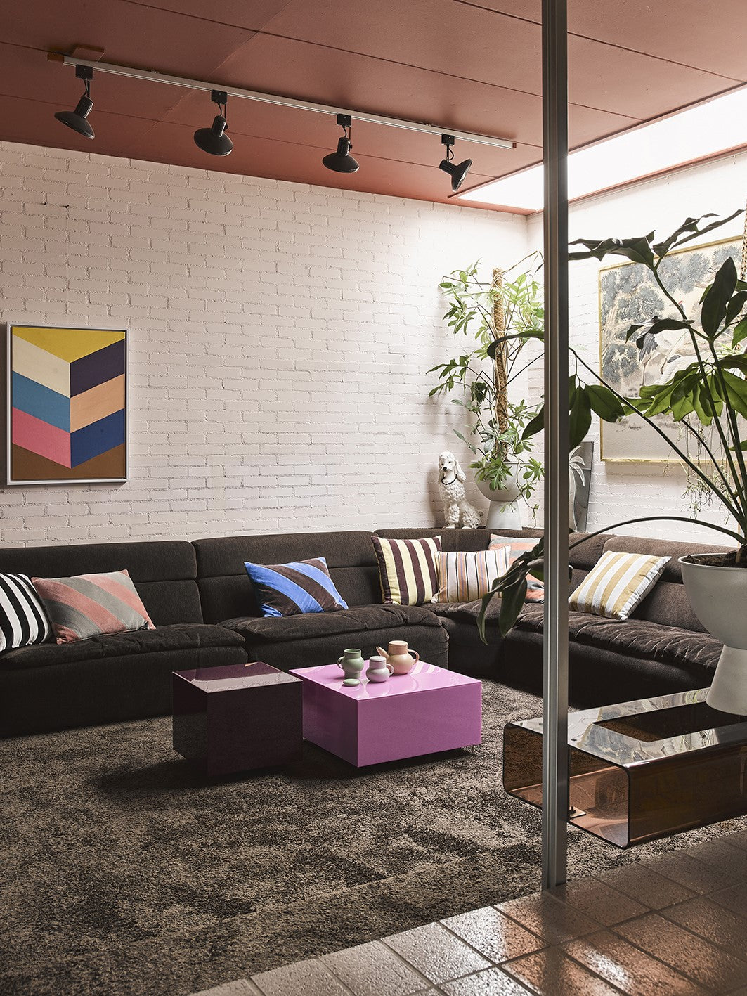 pink square block accent table in living room with brown sectional