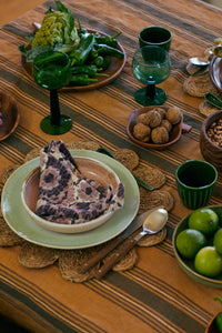 acacia wood apple shape bowl on table with green plate