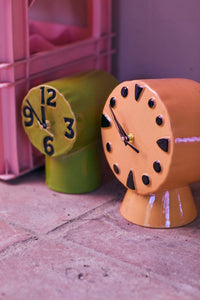 green and peach colored clocks