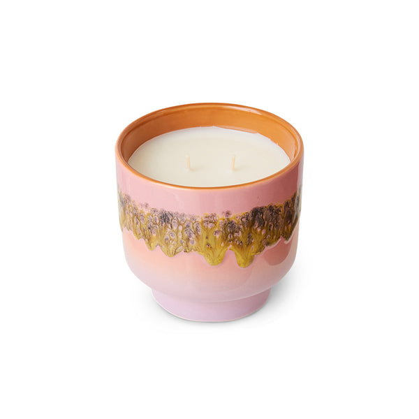 scented candle in orange and pick vessel