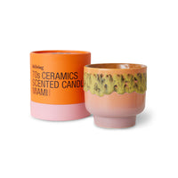 scented candle in orange and pick vessel