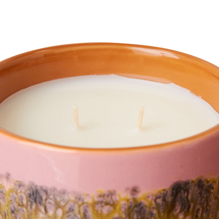 scented candle in orange and pick vessel