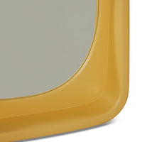 smooth surface ochre yellow mirror in frame with shelf