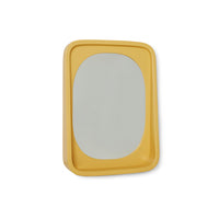 smooth surface ochre yellow mirror in frame with shelf