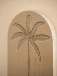 cream earthenware wall tile with palm tree