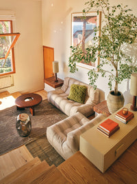 shiny silver accent table in living room with striped togas