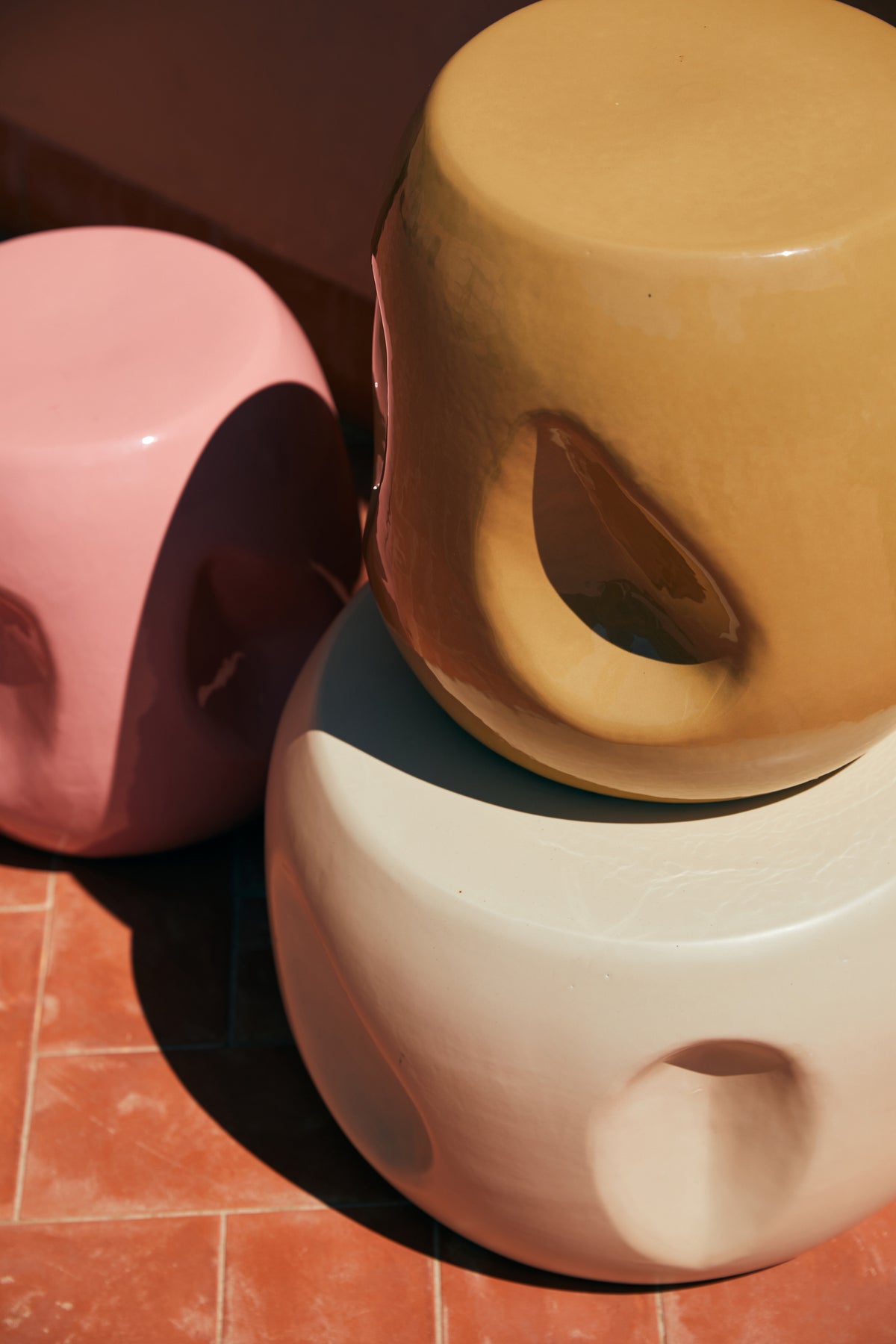 ceramic accent tables in pink, sand and cream