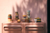 retro style tableware on pink cabinet