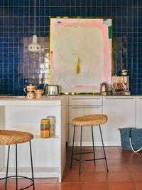 yellow red and green storage jar on shelf in kitchen