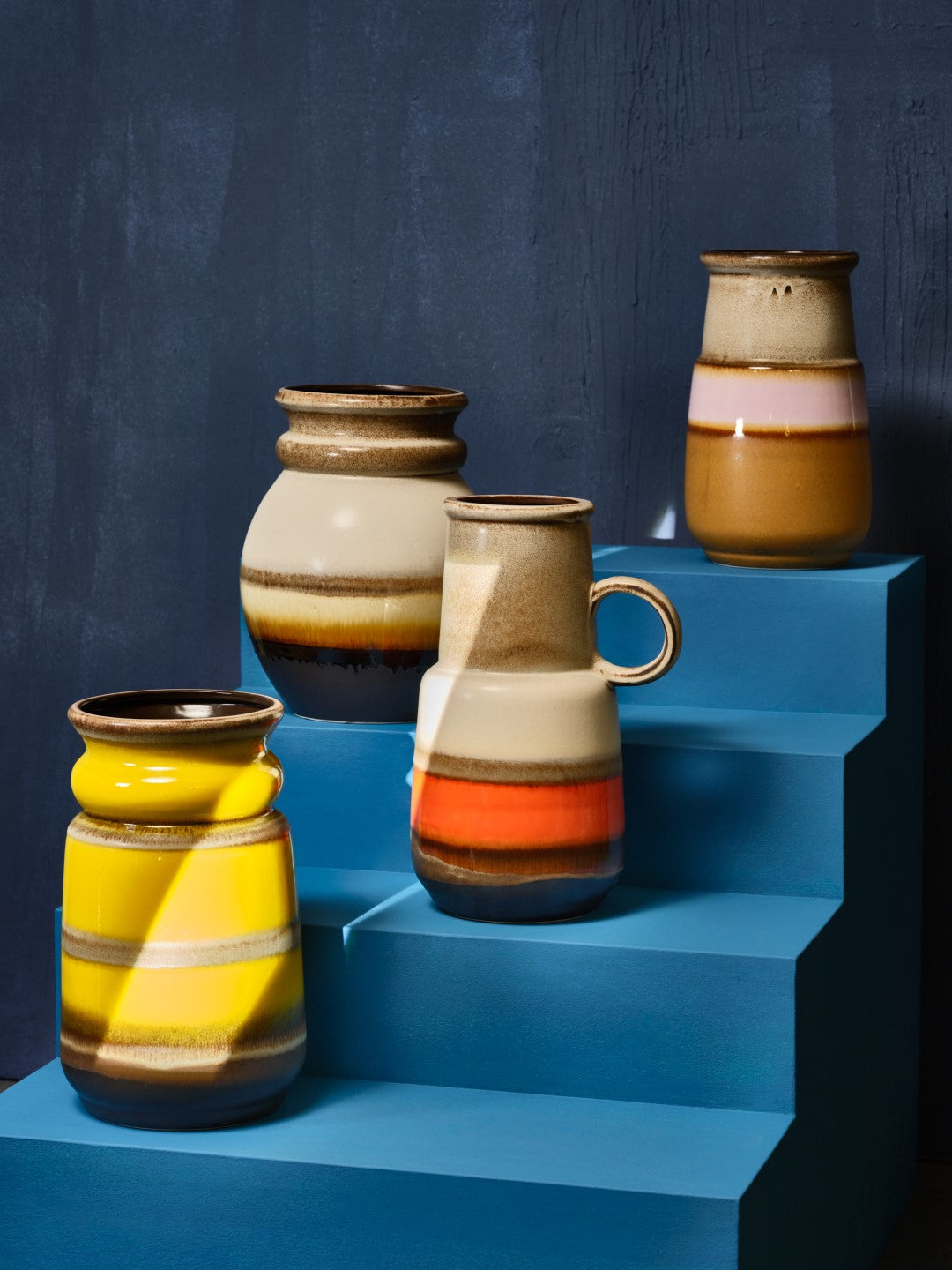 stoneware floor vases on blue staircase