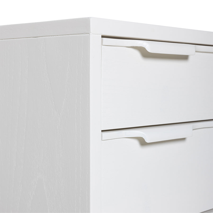 detail of white wooden dresser with 5 drawers