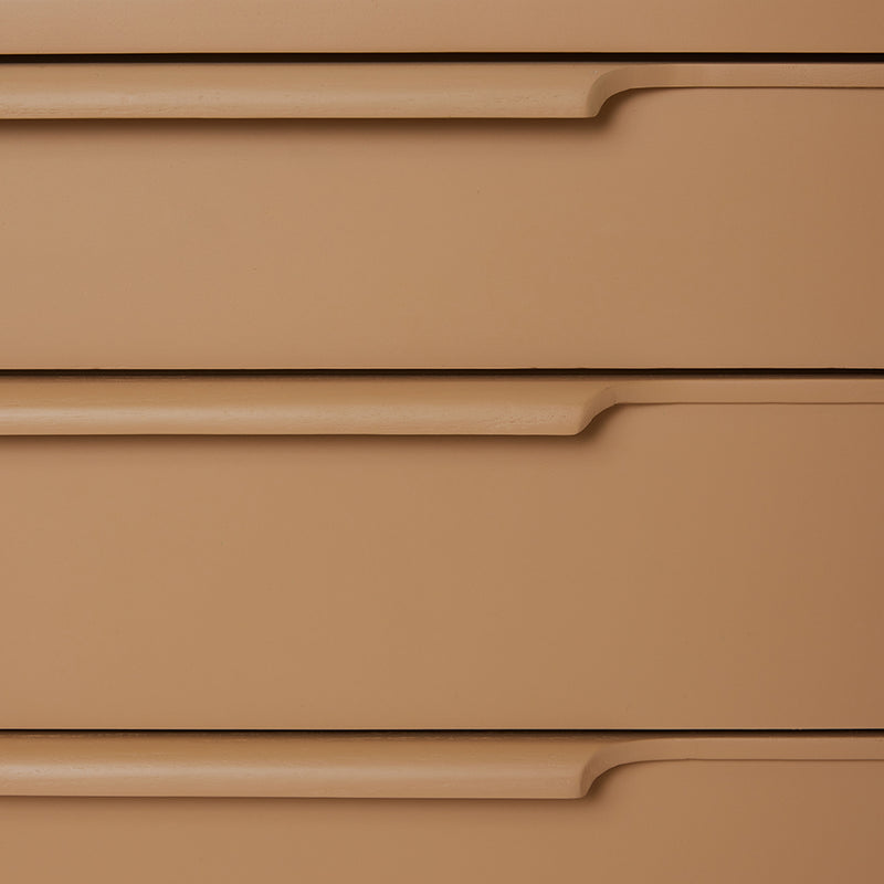 detail of wooden chest of drawers in camel color