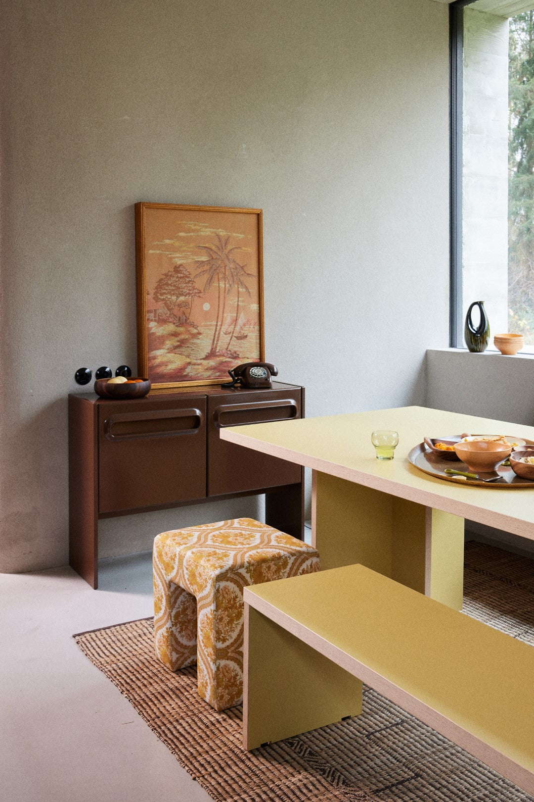 footstool with yellow and off white retro style fabric with yellow dining tale and bench