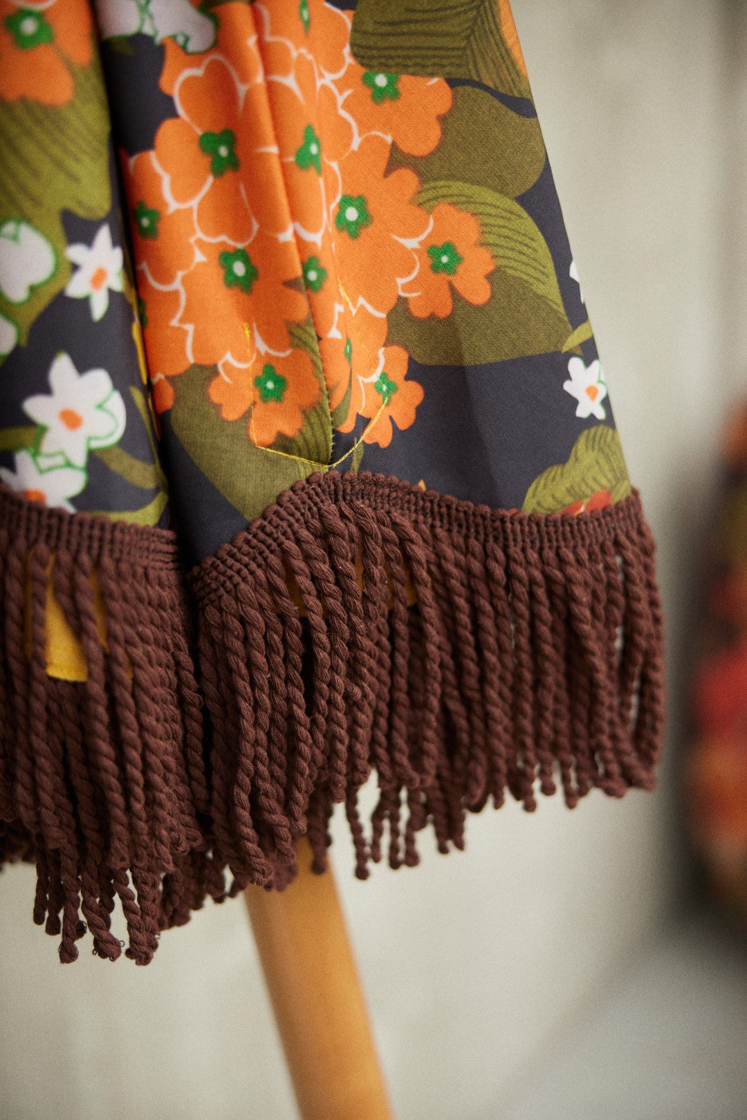 detail of arge patio parasol with retro brown and flower print