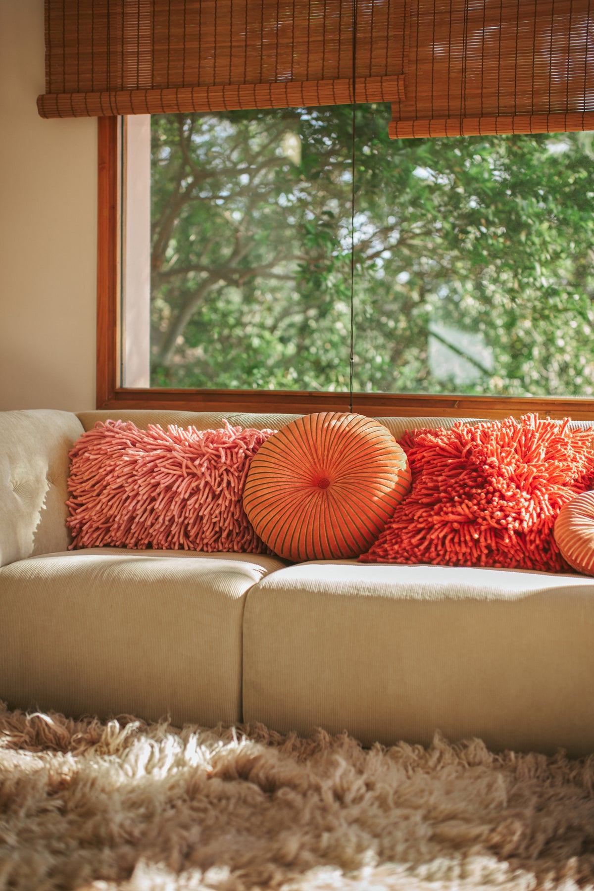 high pile pillows  in pink and red on sofa