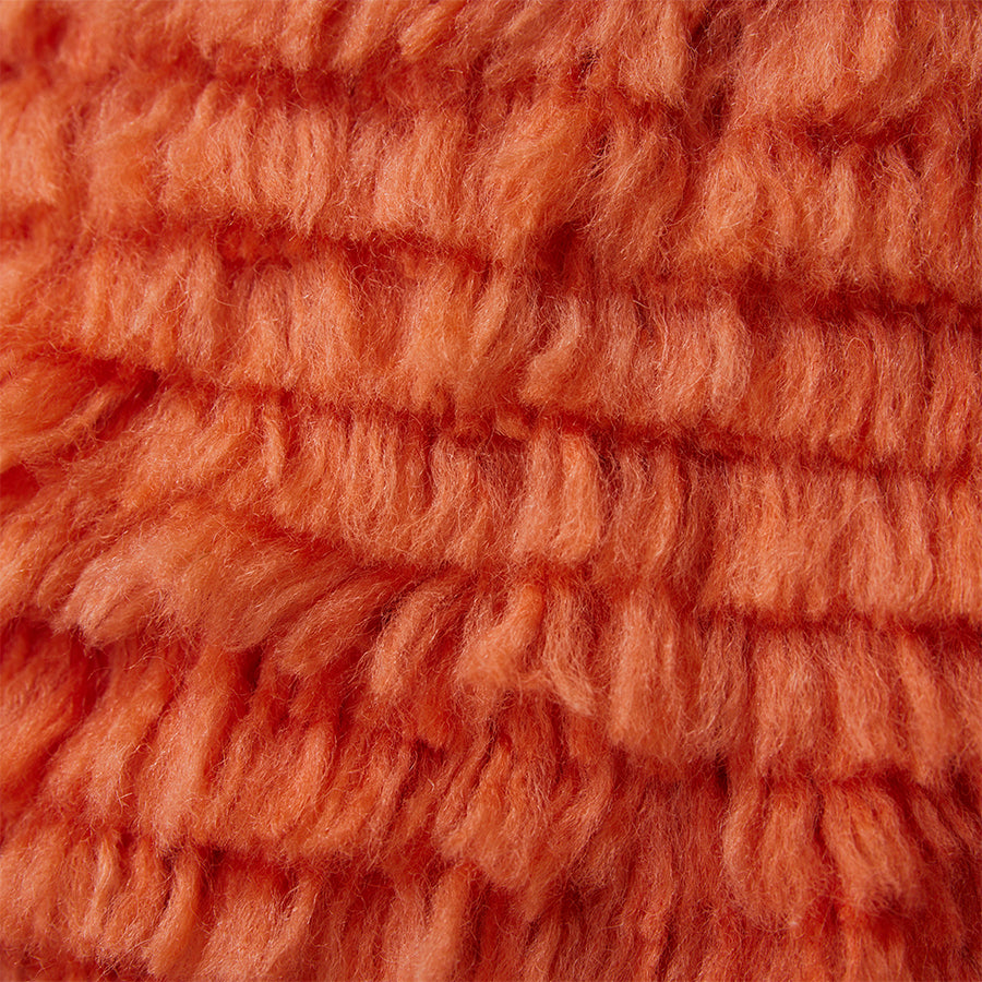 red fluffy textured pillow