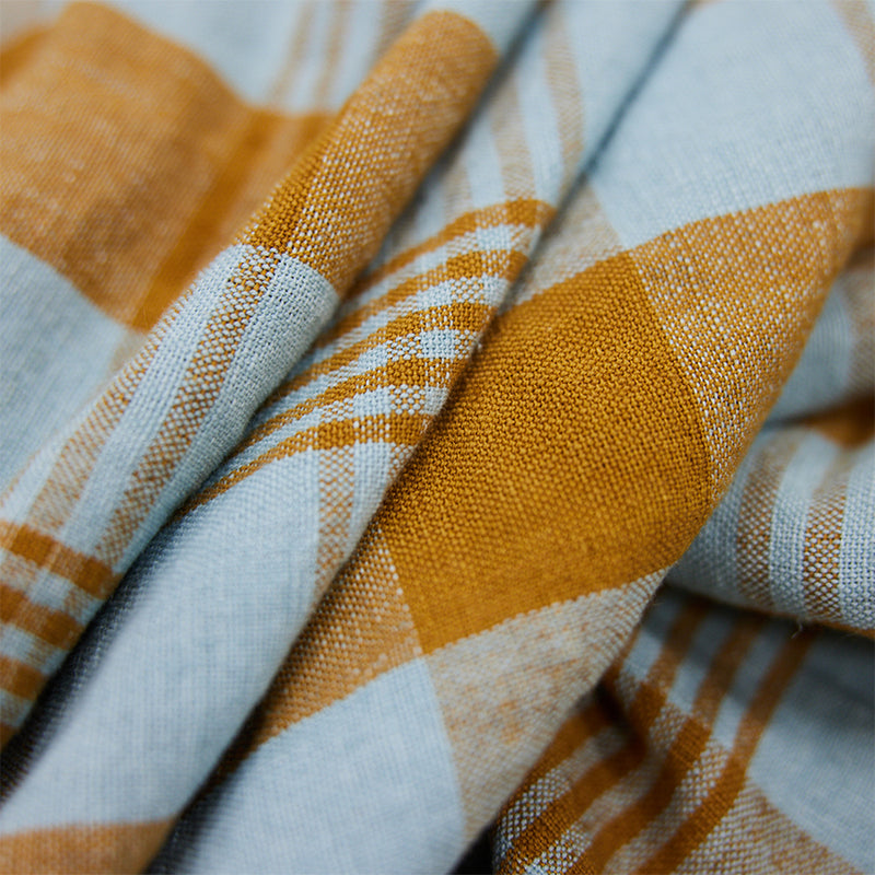 Close-up of a fabric with orange and white checkered pattern