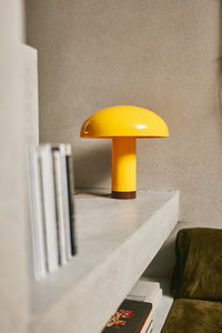 yellow table lamp on concrete console table