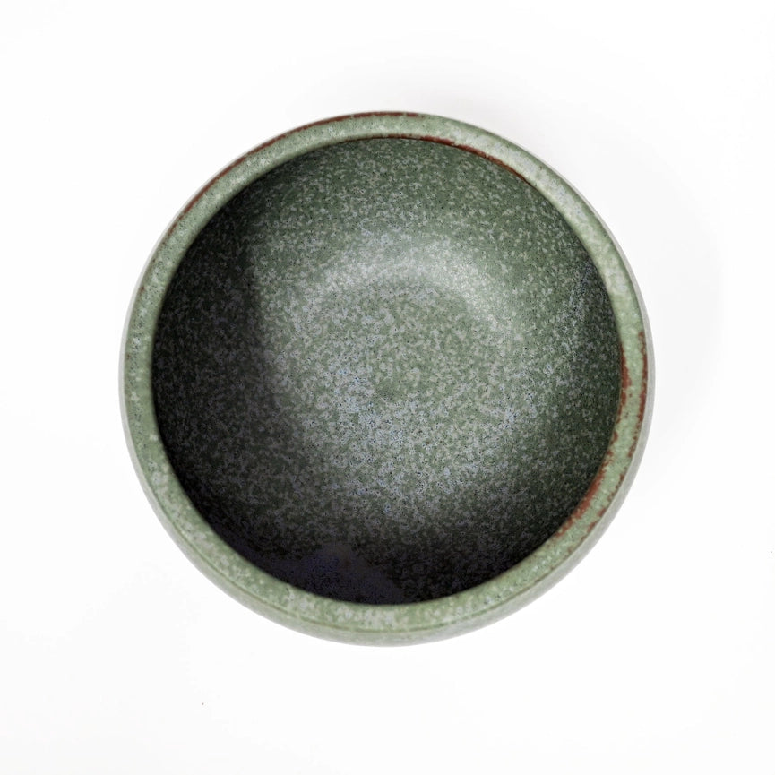 Green ceramic bowl on a white background