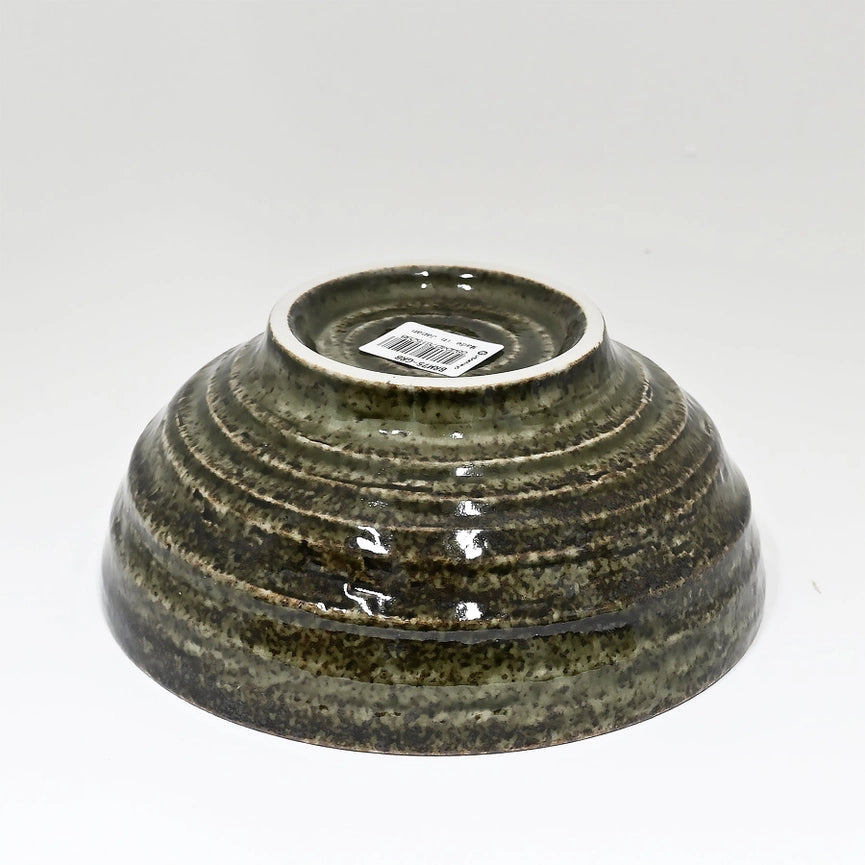 Green ceramic bowl with a label on a white background