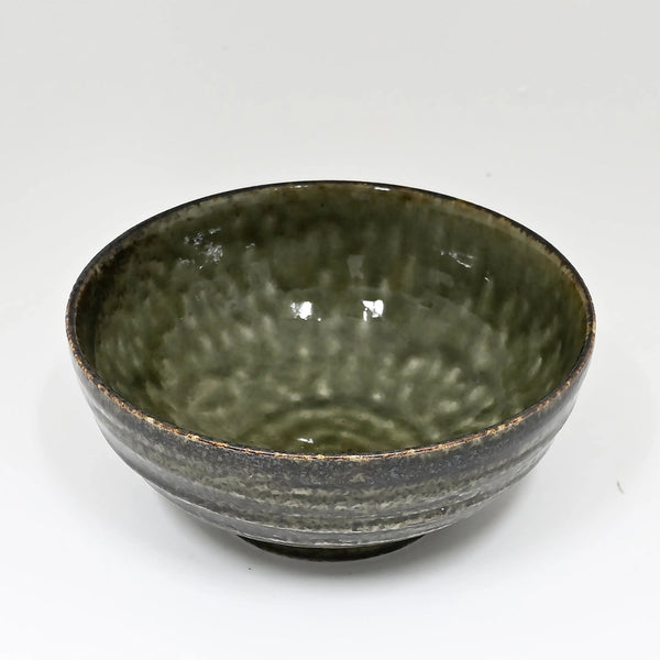 Green ceramic bowl on a white background