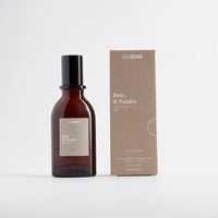 Brown bottle and box with 'Bois & Poudre' branding on a white background