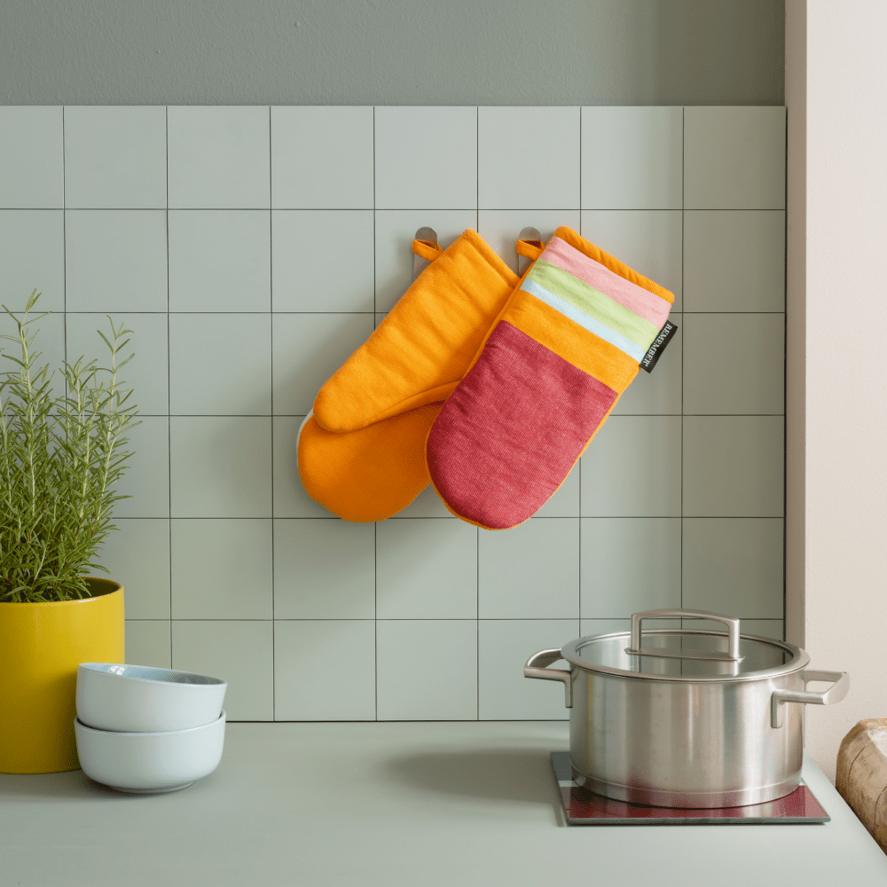 colorful oven gloves hanging in kitchen
