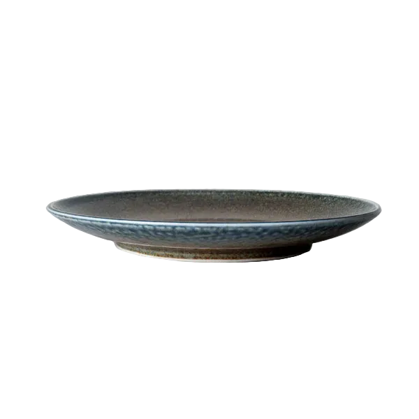 Ceramic plate with textured surface on a white surface