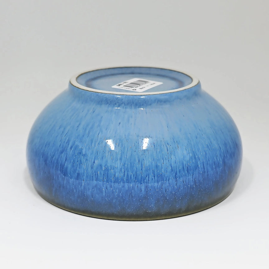 Blue ceramic bowl on a gray background