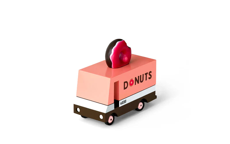 Toy donut truck with a donut on top against a white background