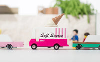 Toy truck with ice cream cone and 'Soft Swerve' branding on a blurred indoor background
