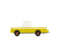 Toy truck with a white bed and yellow body on a white background