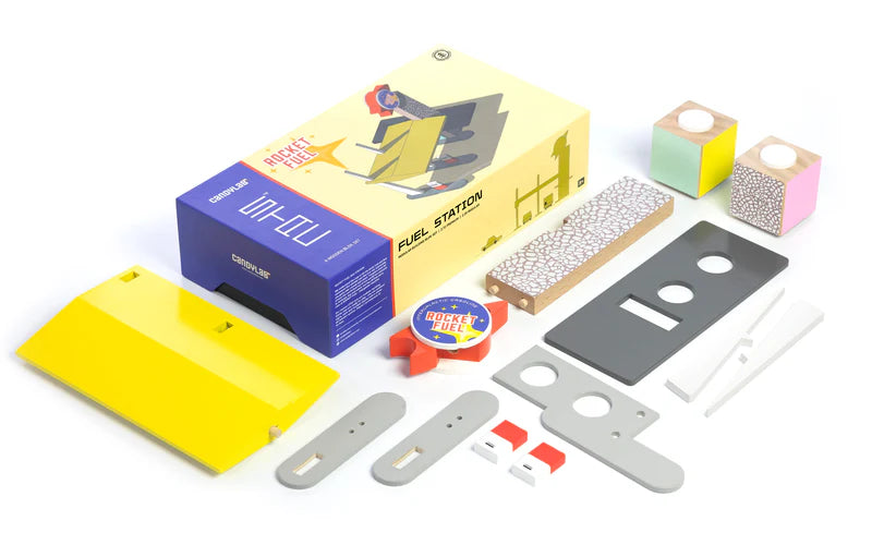 Set of building blocks and components with a colorful box on a white background