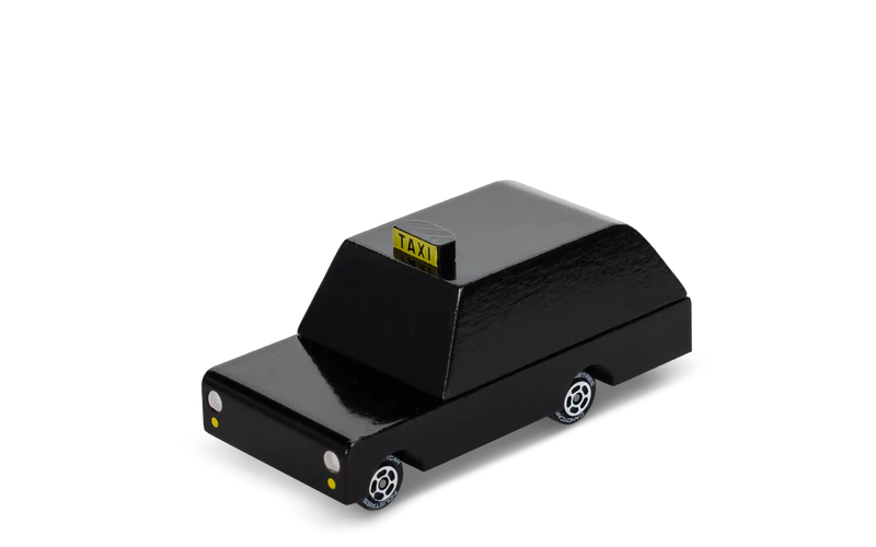 Black toy taxi with yellow 'TAXI' sign on a white background