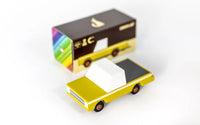 Small yellow toy truck with a matching box on a white background
