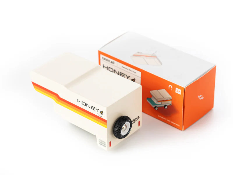 Model of a truck with 'Honey' branding next to its packaging on a white background