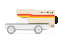Toy truck with a honey container on a white background