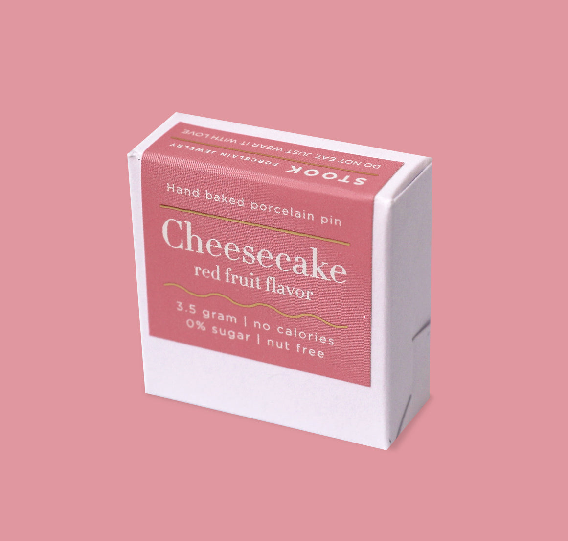 Box of cheesecake-flavored product on a pink background