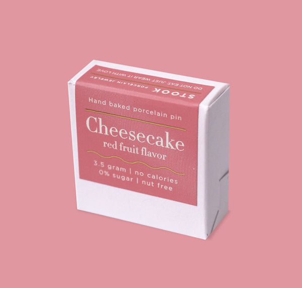 Box of cheesecake-flavored product on a pink background