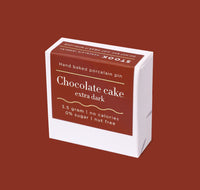 Box of 'Chocolate cake extra dark' hand baked porcelain pin on a brown background