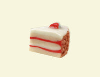 Slice of cake with white frosting and red filling on a beige background