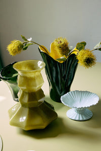 Three decorative vases on a light surface with a neutral background