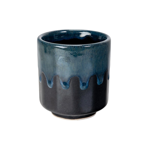 Blue and black ceramic cup with a textured surface on a white background