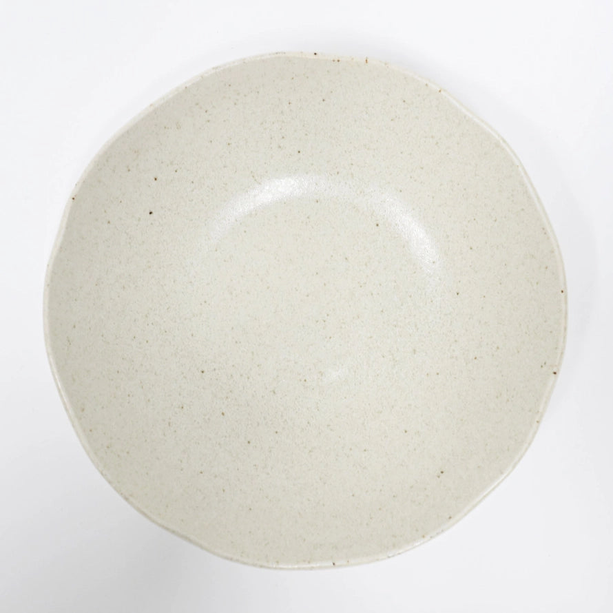 Beige ceramic plate on a white background